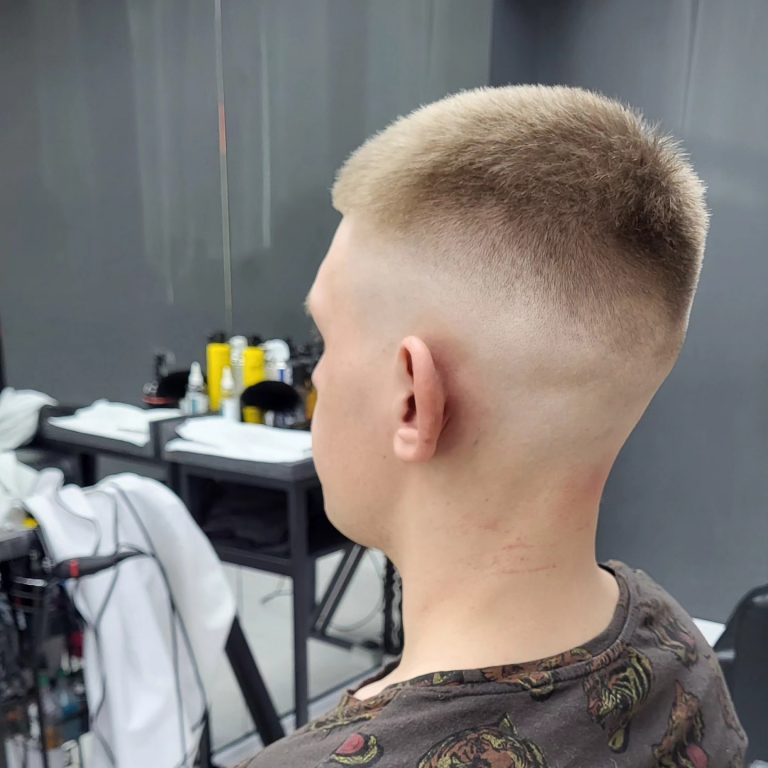Very short buzz cut with a skin fade — rear view