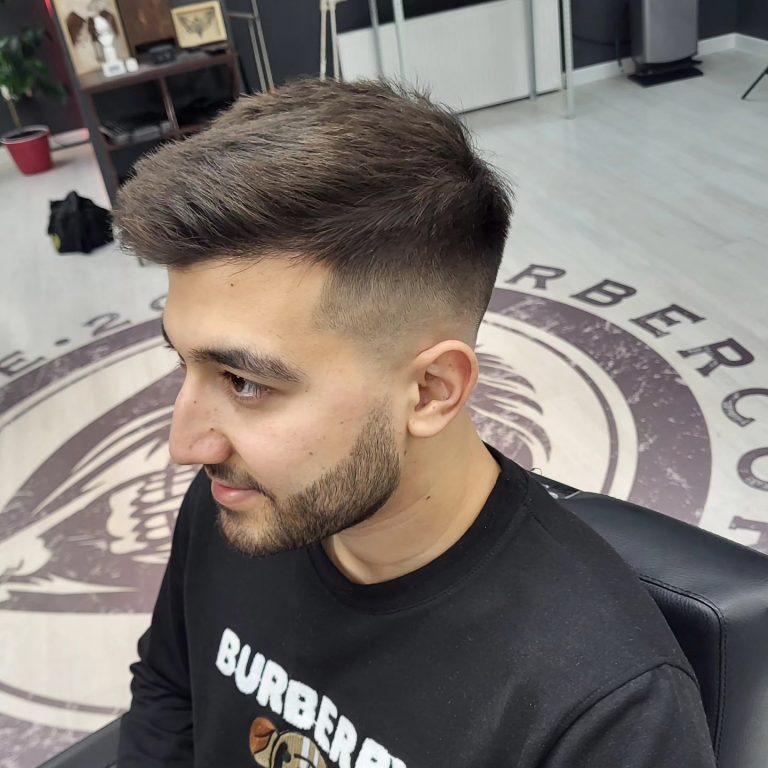 Men's textured top with a fade and short beard — side view